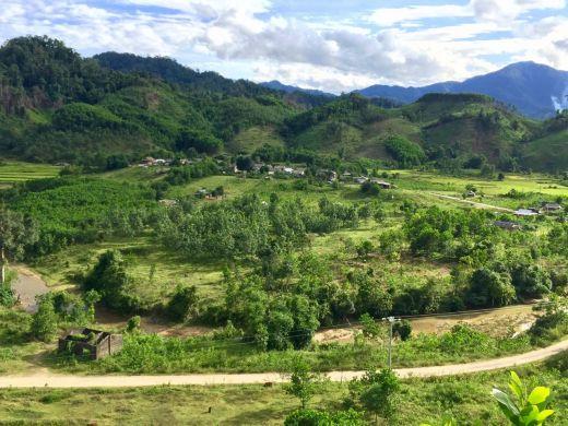 Landscapes near the Lao border, A Lưới district, Vietnam, showing natural forest on the background ridges, acacia plantations in