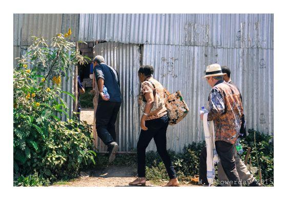 Researchers entering a door to visit a company in Addis Ababa, Ethiopia